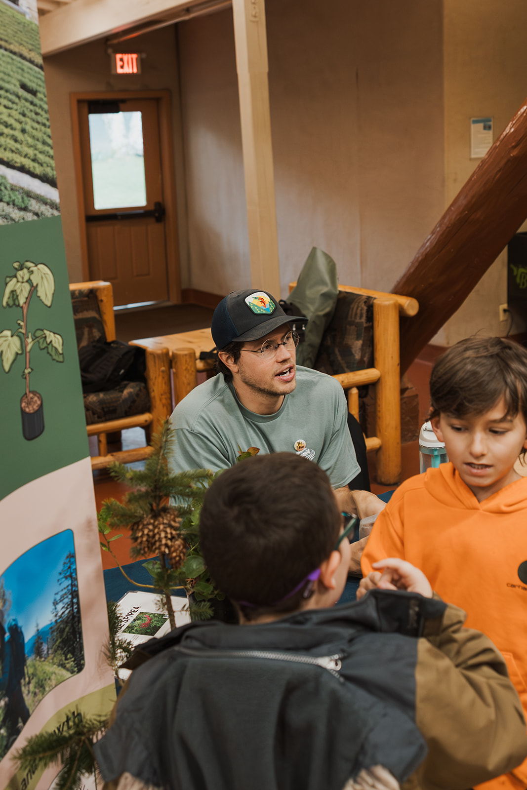 volunteer in green shirt talks to a student
