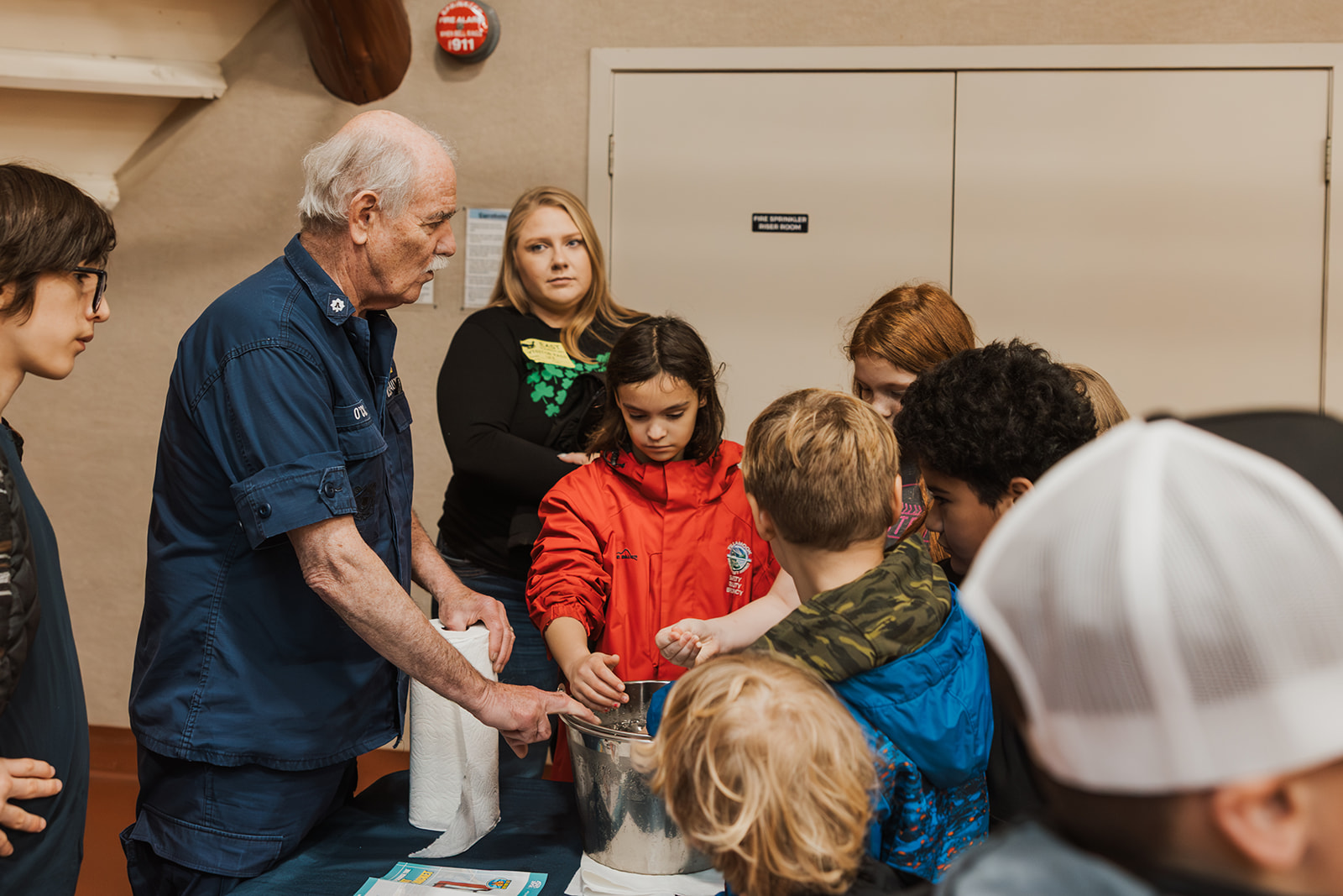 volunteer shows group of students about water safety