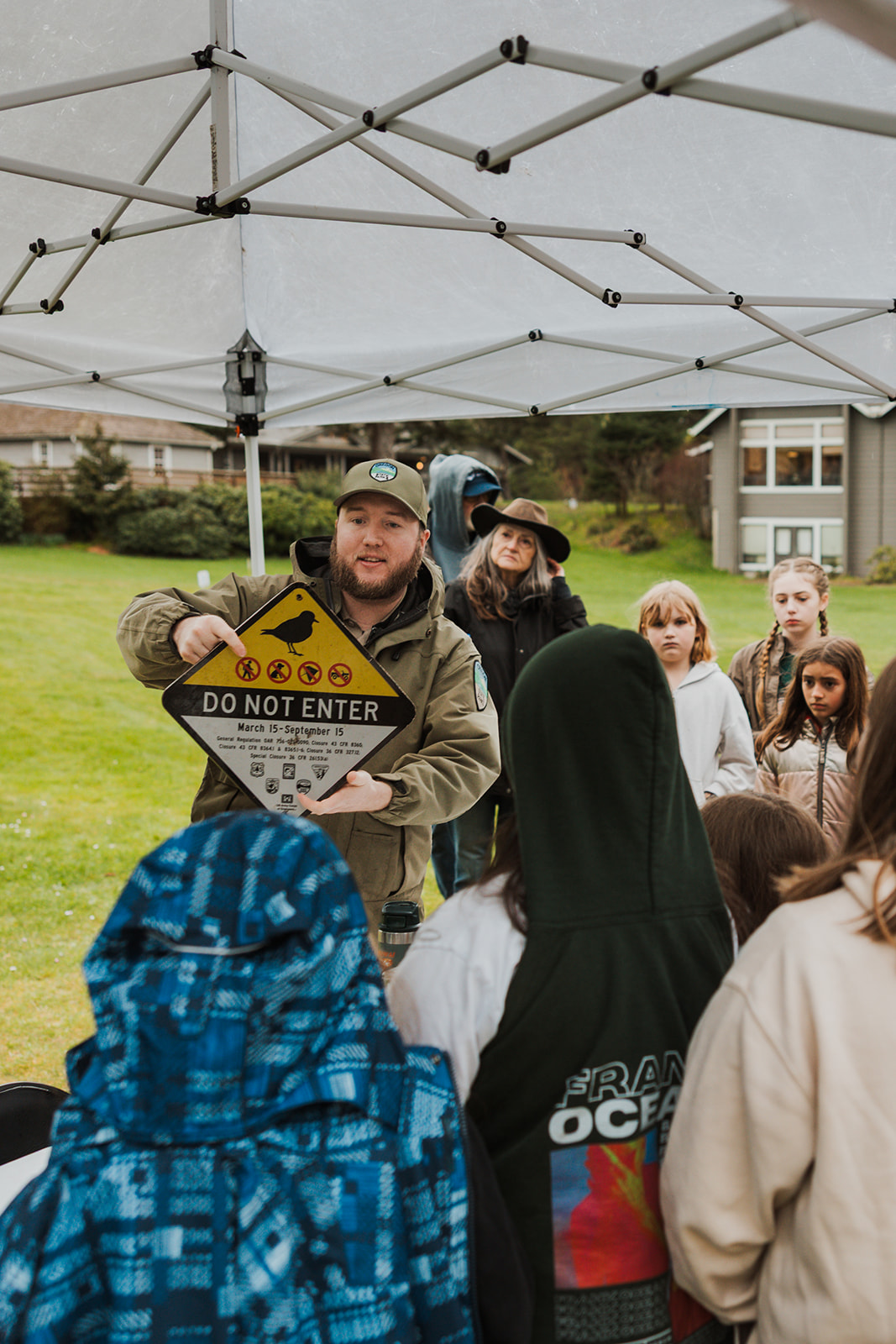 volunteer in state parks green uniform teaching group of students